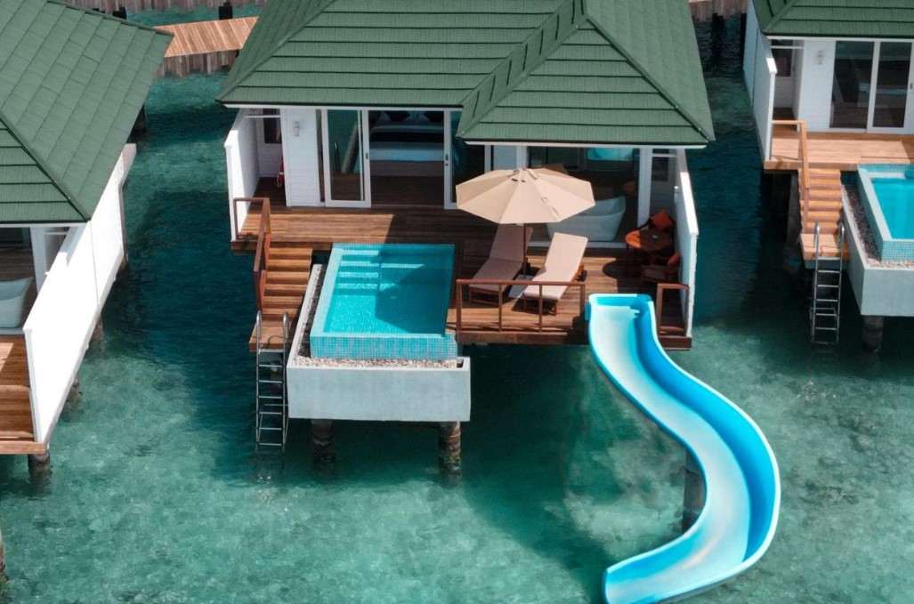 Slide into the biggest pool in the world directly from your Maldives villa!